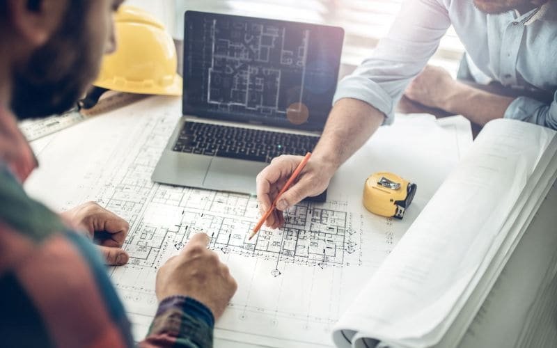 Design and construction team coordinating over drawings
